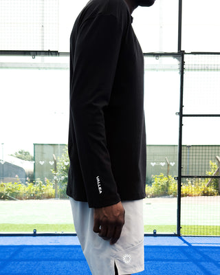 VALLEA Half Zip in Black, half length front zip on a black mid layer